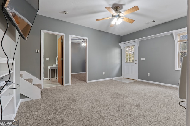 interior space with ceiling fan