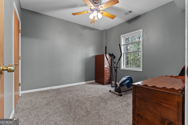 exercise room with ceiling fan and carpet flooring