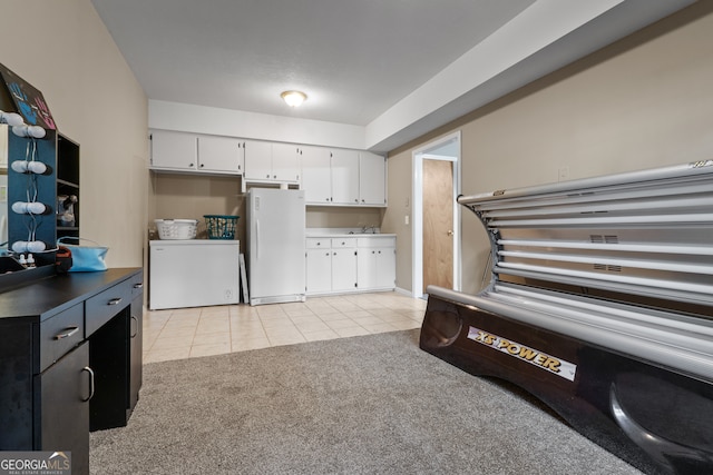 kitchen featuring white cabinetry, sink, refrigerator, light colored carpet, and white refrigerator