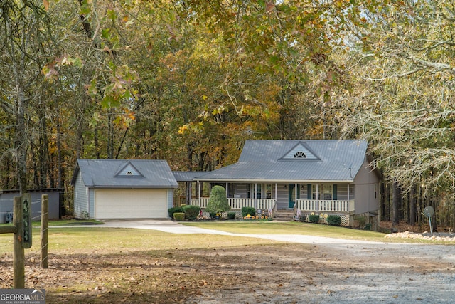 view of front of home featuring a garage, a porch, and a front yard