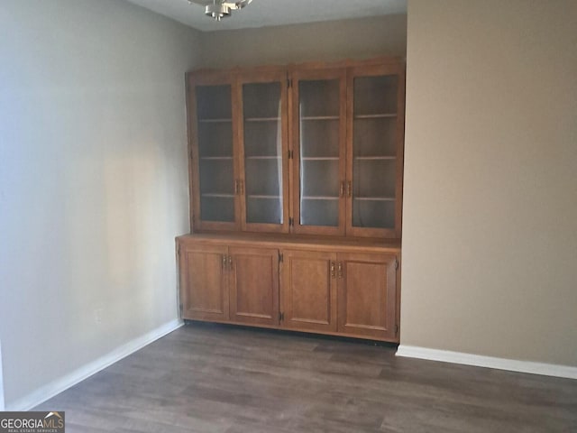 unfurnished dining area with dark hardwood / wood-style flooring