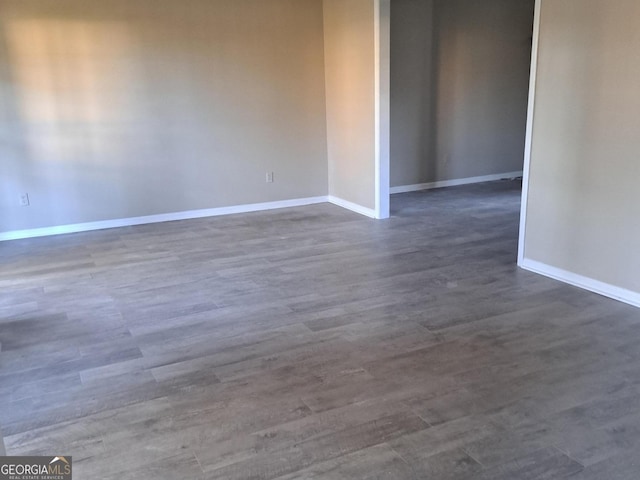 unfurnished room featuring dark hardwood / wood-style floors