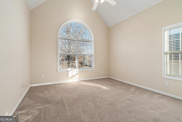 spare room featuring ceiling fan, carpet floors, and high vaulted ceiling