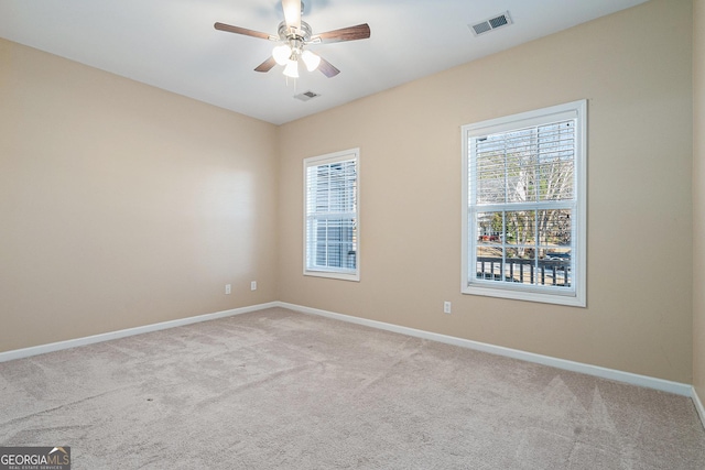 empty room featuring light carpet and ceiling fan