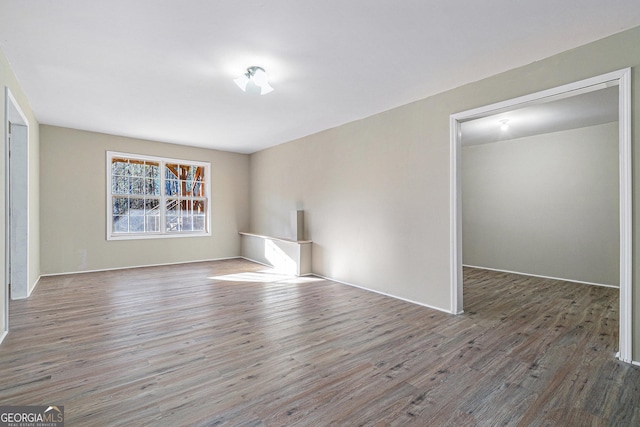 unfurnished room featuring dark hardwood / wood-style flooring