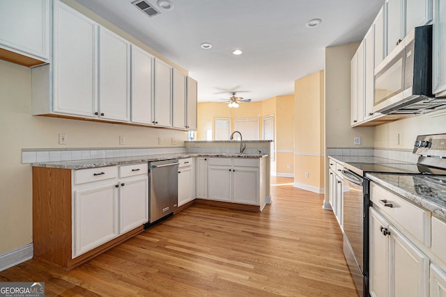 kitchen featuring kitchen peninsula, appliances with stainless steel finishes, ceiling fan, light hardwood / wood-style flooring, and white cabinets