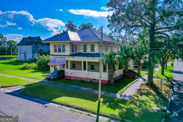 exterior space with a balcony and a yard