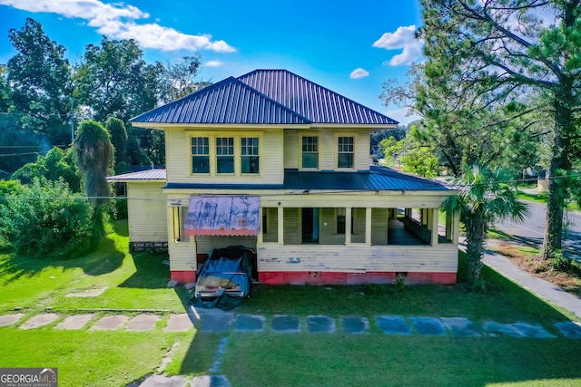 exterior space with a porch and a yard