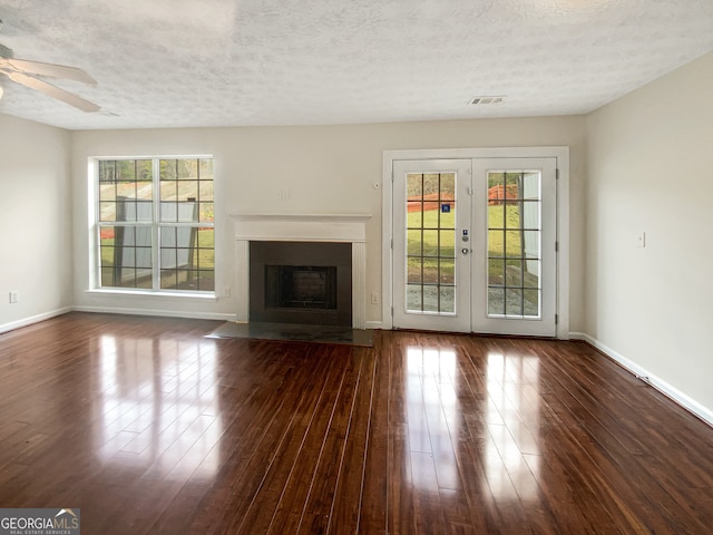 unfurnished living room with french doors, a textured ceiling, dark hardwood / wood-style floors, and ceiling fan