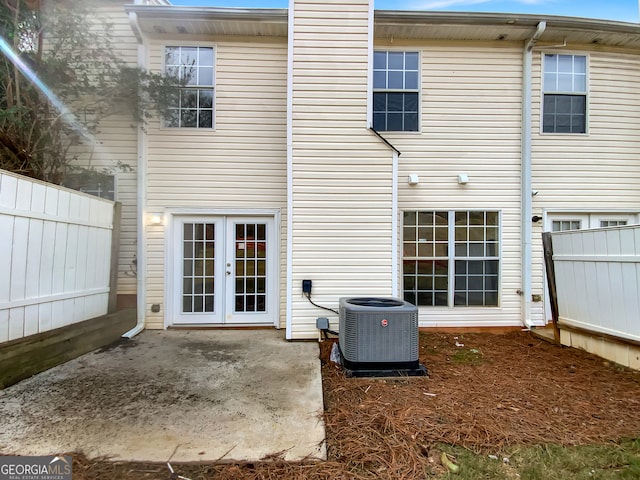 back of property featuring french doors and central AC unit