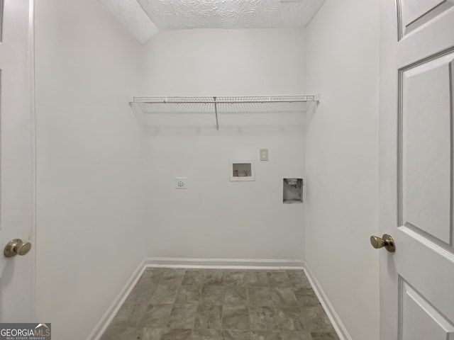 laundry area featuring electric dryer hookup, washer hookup, and a textured ceiling