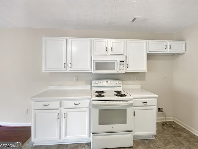 kitchen featuring white cabinetry and white appliances