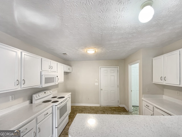 kitchen with white appliances, white cabinetry, and a textured ceiling