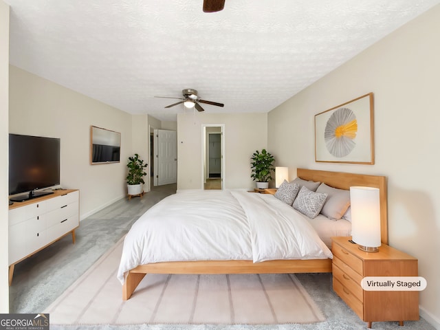 bedroom with light carpet, a textured ceiling, and ceiling fan