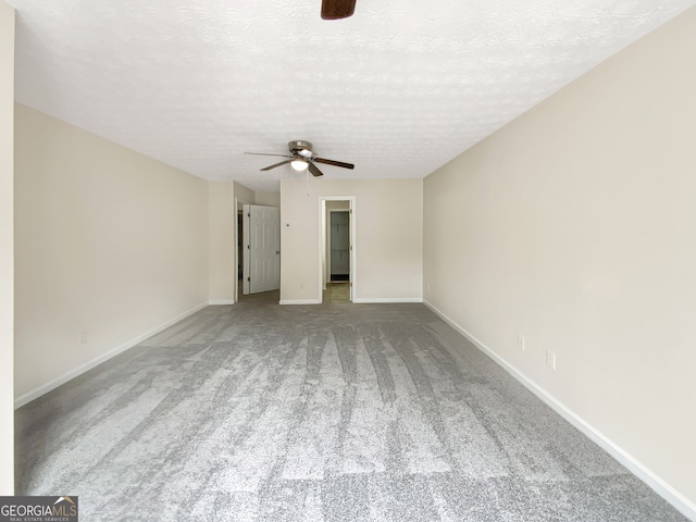 unfurnished room with a textured ceiling, light colored carpet, and ceiling fan