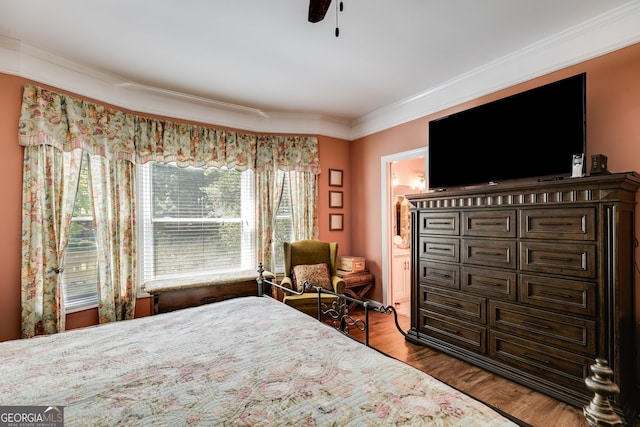 bedroom featuring ceiling fan, connected bathroom, light wood-type flooring, and ornamental molding