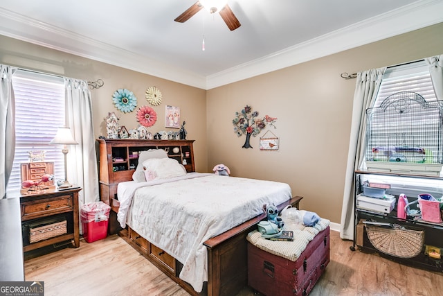 bedroom with light wood-type flooring, multiple windows, ceiling fan, and crown molding