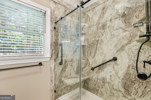 bathroom featuring walk in shower and a wealth of natural light