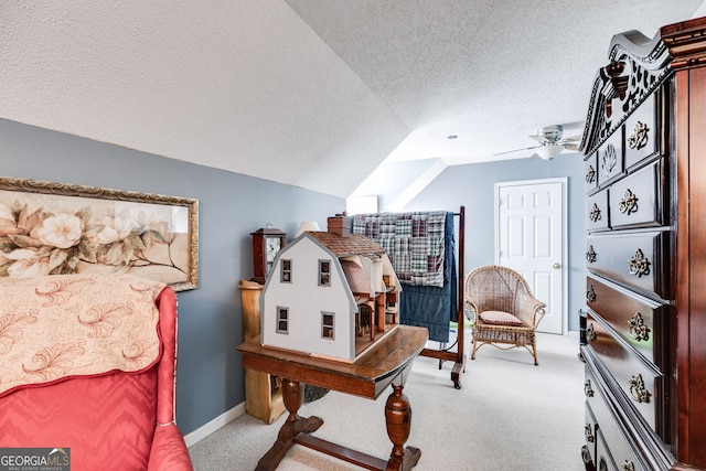 interior space featuring ceiling fan, a textured ceiling, lofted ceiling, and light colored carpet