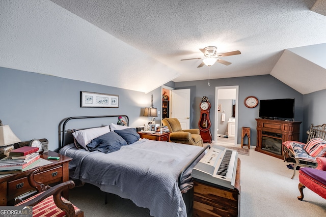 bedroom featuring ensuite bathroom, ceiling fan, vaulted ceiling, and carpet