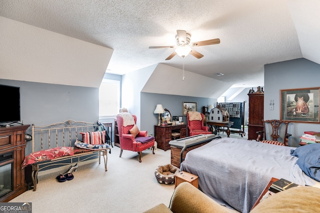 bedroom featuring ceiling fan, a textured ceiling, lofted ceiling, and carpet