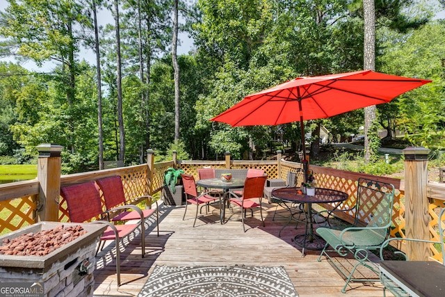 wooden deck featuring a fire pit