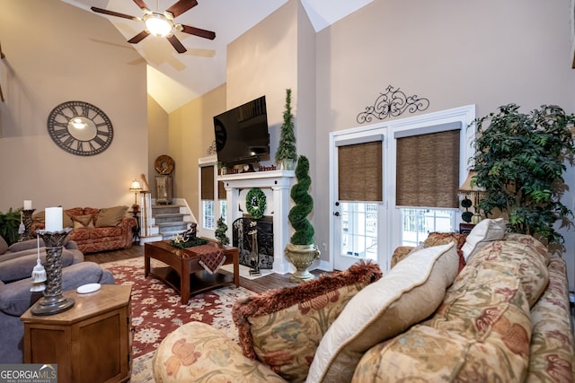 living room featuring hardwood / wood-style floors, high vaulted ceiling, and ceiling fan