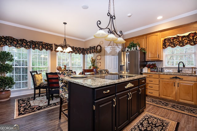 kitchen featuring stainless steel fridge, black electric stovetop, crown molding, dark wood-type flooring, and sink