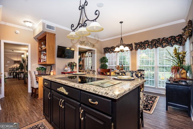 kitchen with black electric cooktop, crown molding, dark hardwood / wood-style flooring, and a center island