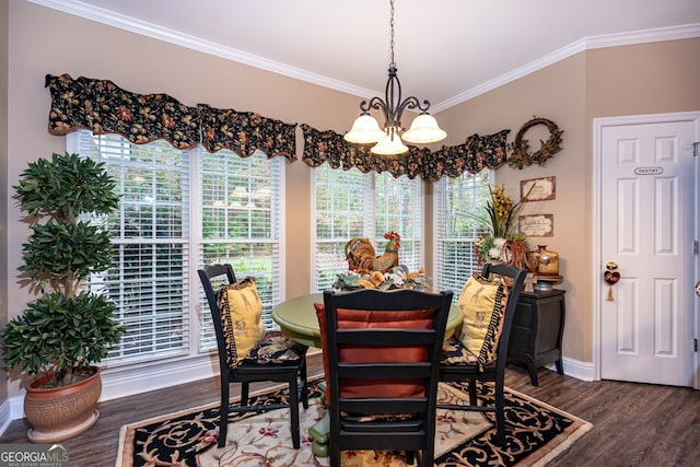 dining area with ornamental molding, a notable chandelier, and dark wood-type flooring