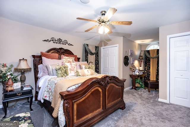 carpeted bedroom featuring two closets and ceiling fan