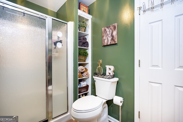 bathroom with a shower with shower door and toilet