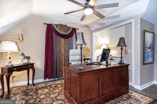 office space with ceiling fan, dark hardwood / wood-style floors, and vaulted ceiling