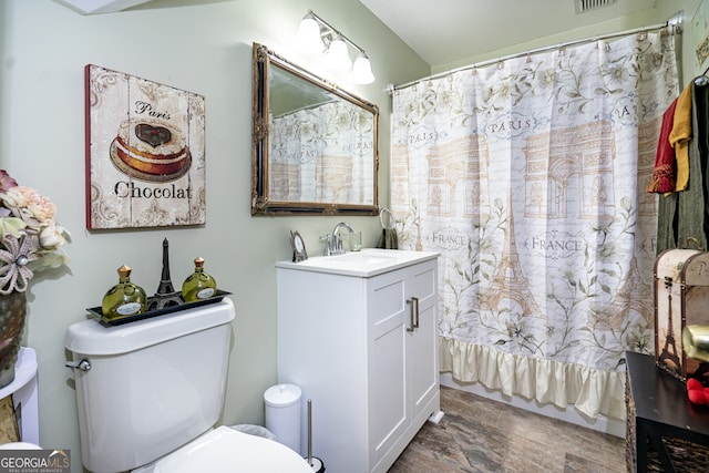 bathroom featuring vanity, toilet, and a shower with shower curtain