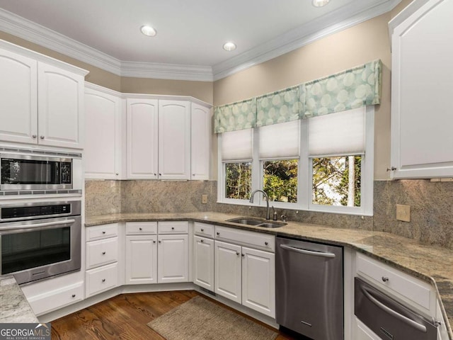 kitchen with stainless steel appliances, white cabinetry, dark wood-type flooring, and sink