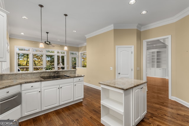 kitchen with light stone counters, dark wood-type flooring, pendant lighting, a center island, and white cabinetry