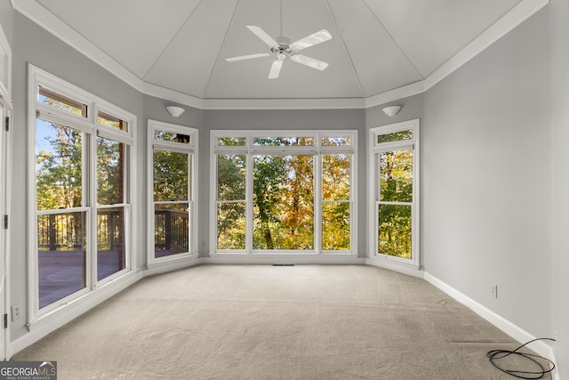 unfurnished sunroom featuring vaulted ceiling, ceiling fan, and a healthy amount of sunlight