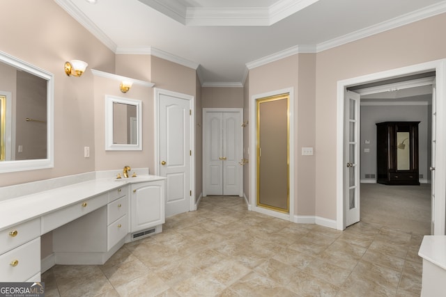 bathroom with vanity, a shower with shower door, and crown molding