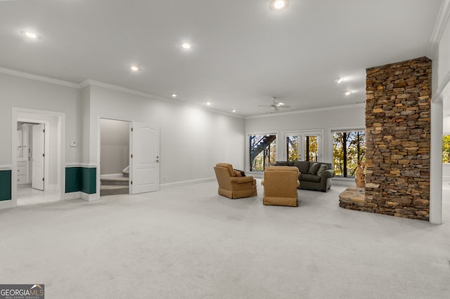 sitting room featuring light carpet, ceiling fan, and crown molding