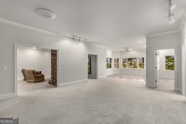 unfurnished living room with light carpet, crown molding, ceiling fan, and track lighting