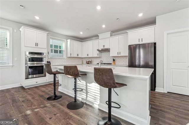 kitchen featuring white cabinets, a healthy amount of sunlight, and stainless steel appliances