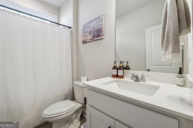 bathroom featuring toilet and vanity