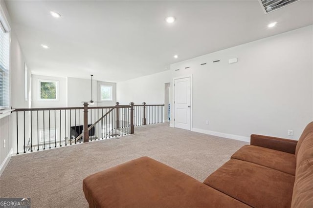 living area featuring carpet flooring and ceiling fan