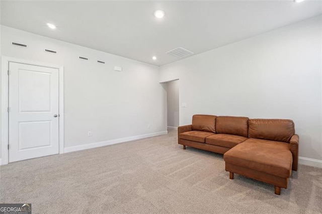 sitting room featuring light colored carpet