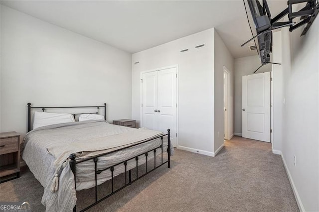 carpeted bedroom with a closet