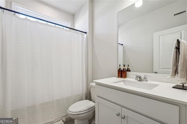 bathroom featuring vanity and toilet