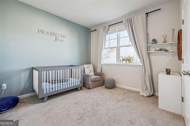 carpeted bedroom featuring a crib