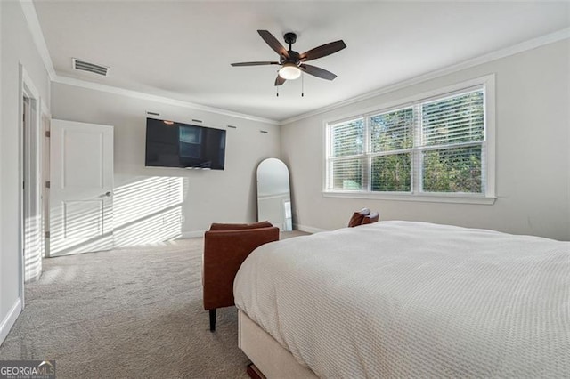 carpeted bedroom featuring ornamental molding and ceiling fan