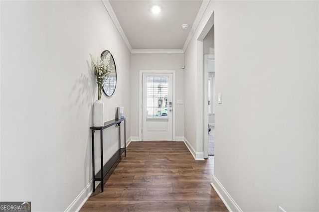 entryway with ornamental molding and dark hardwood / wood-style floors