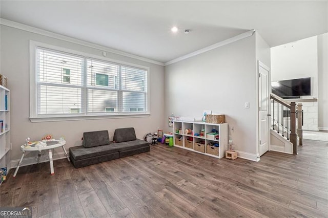 sitting room with ornamental molding and hardwood / wood-style floors